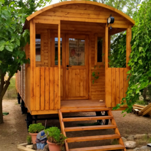Casas de Madera Torrevieja - 16,8 m2 - Diáfana - Gypsy Wagon - Modelo Jimmy - mini casa sobre ruedas de medidas 840x240-GYPSY WAGON frontal con macetas